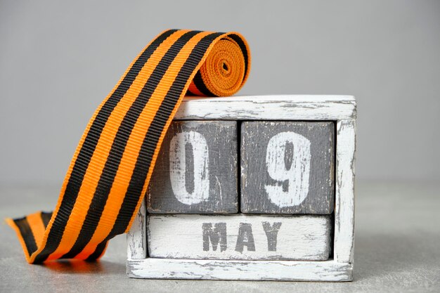 09 mei houten kalender en St George lint grijs backgroundConcept voor Victory Day over fascisme