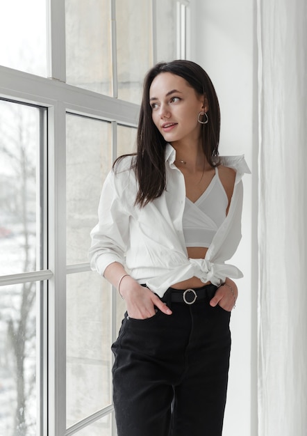 1 white young romantic stylish woman in white shirt by the window