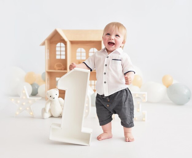 1 year decorations background Happy birthday holiday Balloons and gifts Cake smash party Child boy with number 1