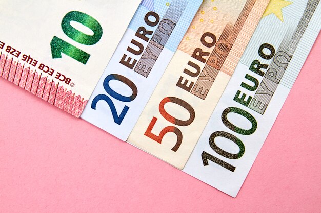 10, 20, 50, 100 Euro banknotes on pink background