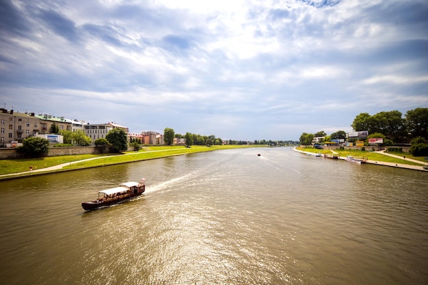 10 of July2017KrakowPolandTourist boat on VIstula river with Wawel Royal Castle in the background Poland