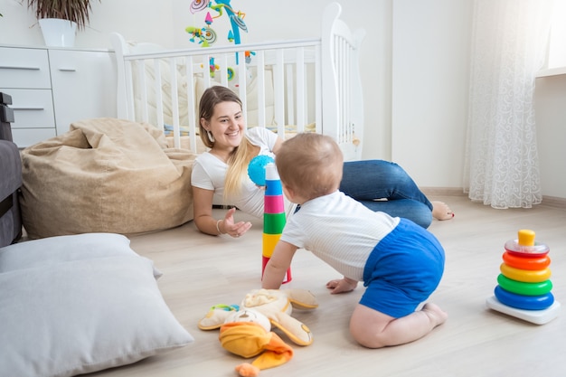 10 months old baby boy crawling and having fun on floor at living room