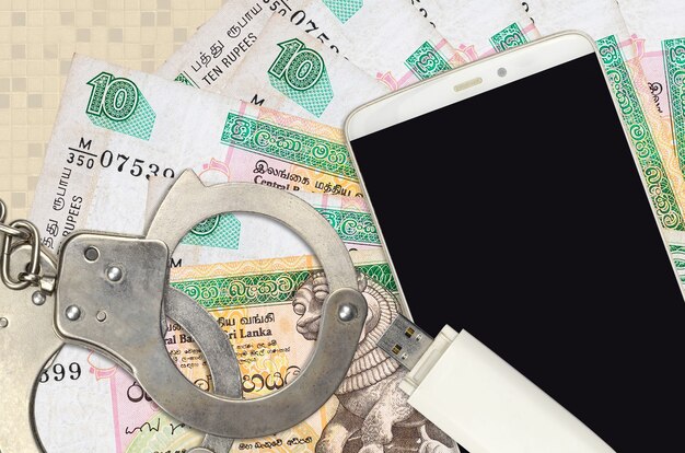 10 Sri Lankan rupees bills and smartphone with police handcuffs