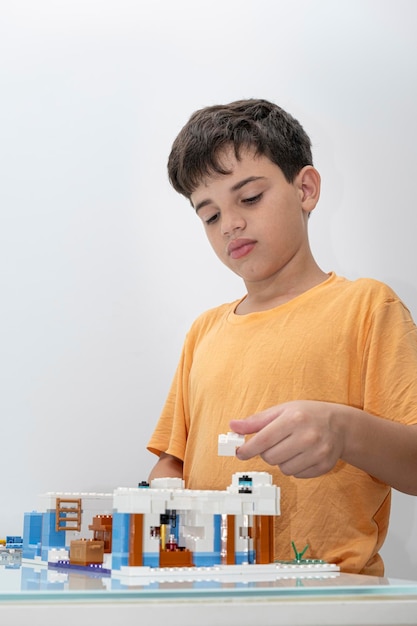 10 year old Brazilian child in pajamas playing with building blocks_13