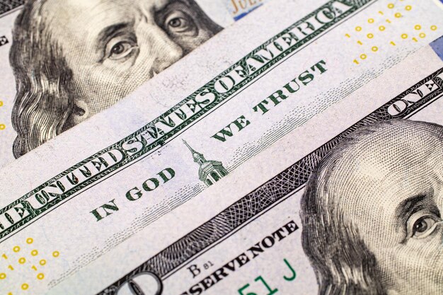 A 100 bill with focus on In God We Trust US banknotes closeup Extreme closeup dollars