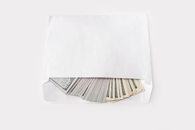 100 dollar banknotes in a white envelope on a white background