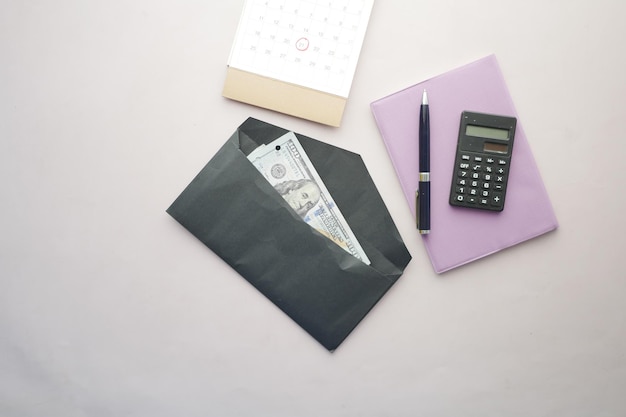 100 dollar cash in a envelope on a desk