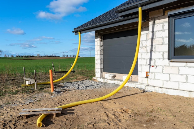 100mm diameter yellow pvc pipe connected to the end of the gutter on the roof protected against water