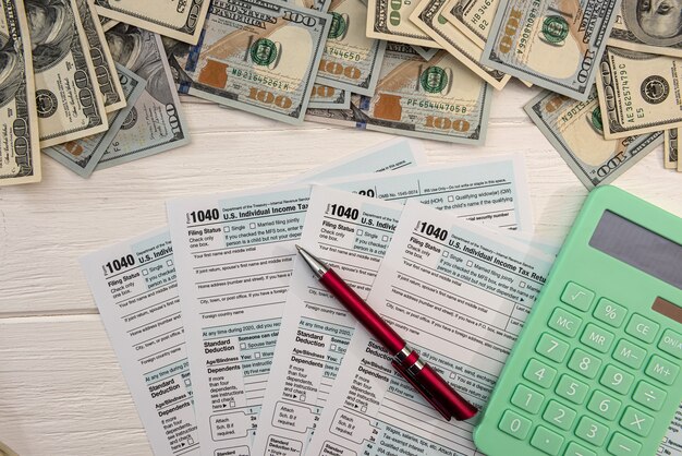 1040 individual form, with us money.  Tax time concept. accountant