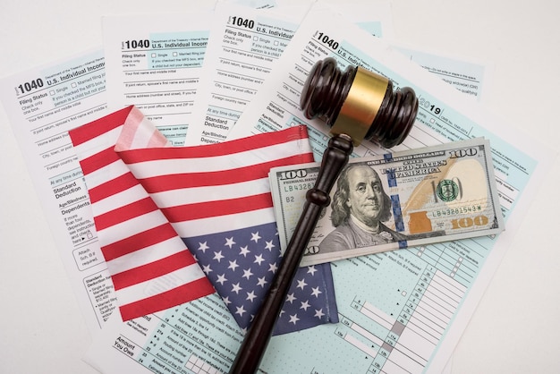 1040 individual tax form with gavel and dollars bills on desk