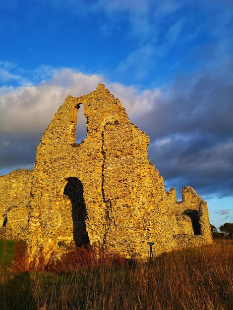 11th century castle acre priory at winter sunset from public land