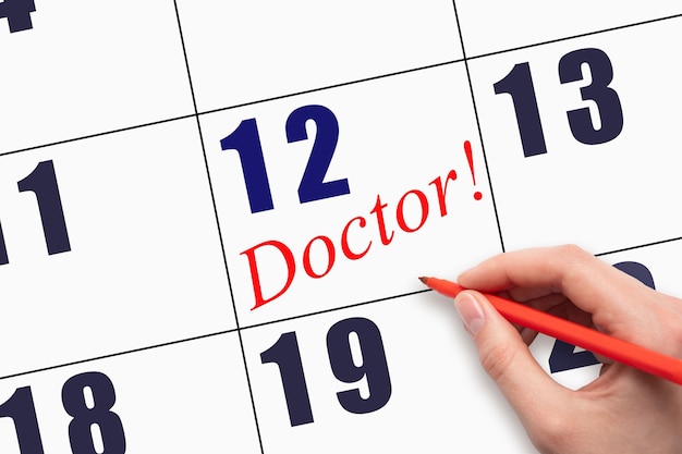12th day of the month Hand writing text DOCTOR on calendar date
