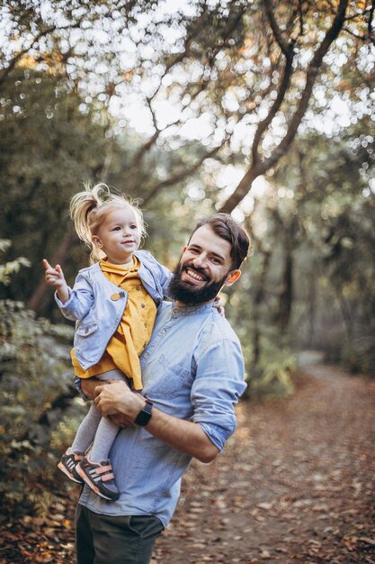 13072018 Vinnitsa Ukraine young happy and stylish father walking in the autumn park together with his sweet little daughter enjoying the sunny weather