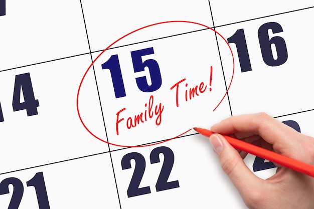 15th day of the month Hand writing text FAMILY TIME and circling the calendar date