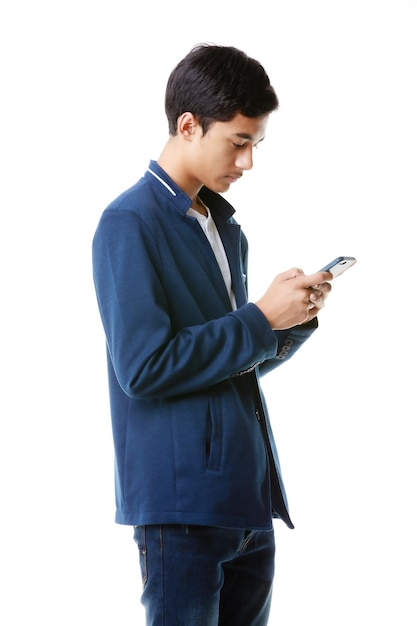 A 15yearold Asian junior high school student holding and typing chat message on mobile phone screen to keep in touch with social world over Internet