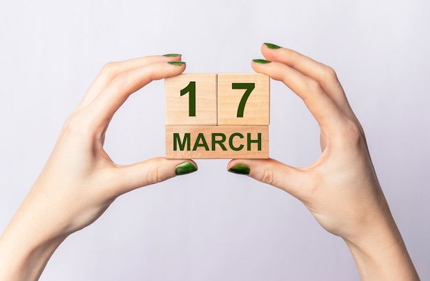 17 march inscription on wooden calendar in female hands.