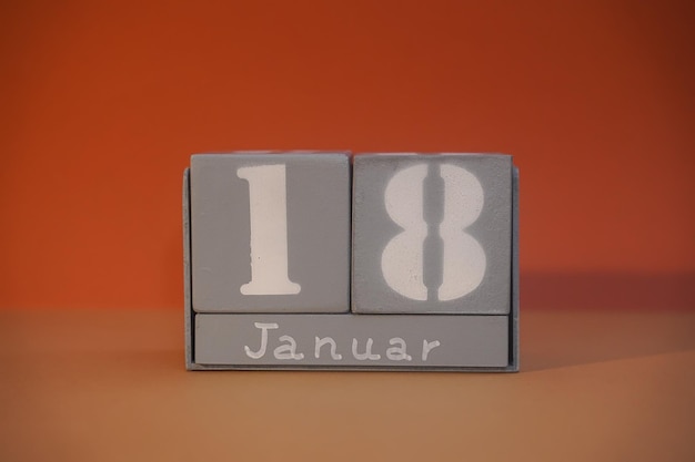 18 Januar on wooden grey cubes Calendar cube date 18 January Concept of date Copy space for text or event Educational cubes Cube shape calendar for January 18 with empty space Selective focus