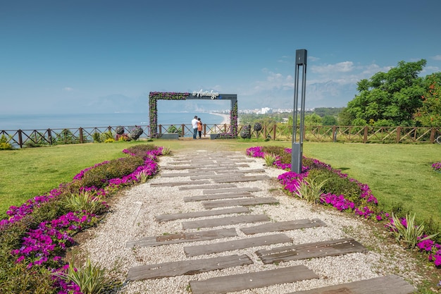 18 May 2022 Antalya Turkey A couple in love on their honeymoon hug and admire the view of the famous Konyaalti beach from a viewing point