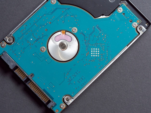 2.5 inch hard disk drive for laptop or computer on a dark paper background. Top view, flat lay