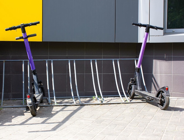 2 electric scooters in the parking lot Ecological transport parking of electric scooters bicycles rent