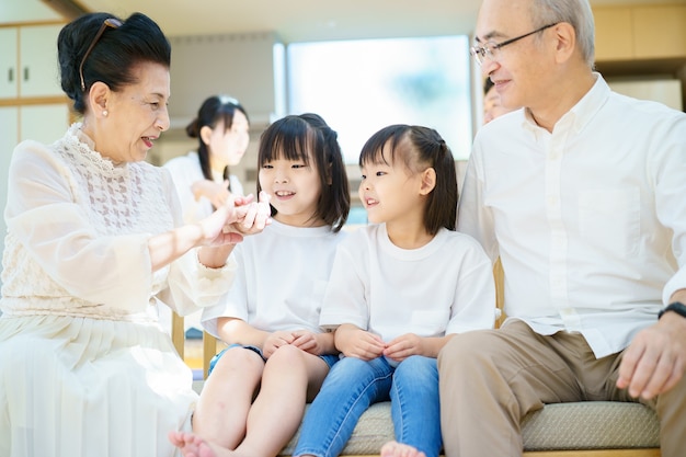 2 little granddaughters talking to grandparents in the room