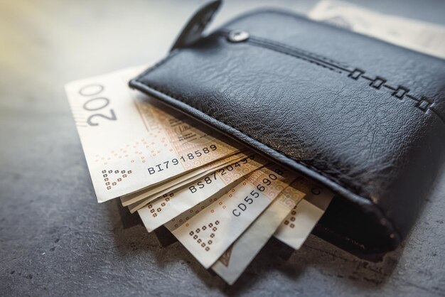 Photo 200 100 zloty banknotes in a black male wallet