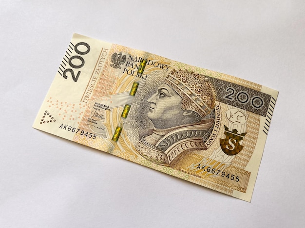 A 200 zloty bill in close-up on a white isolated background. Polish curreny