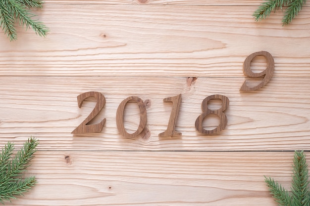 2018 - 2019 number with Christmas decorations on wooden background