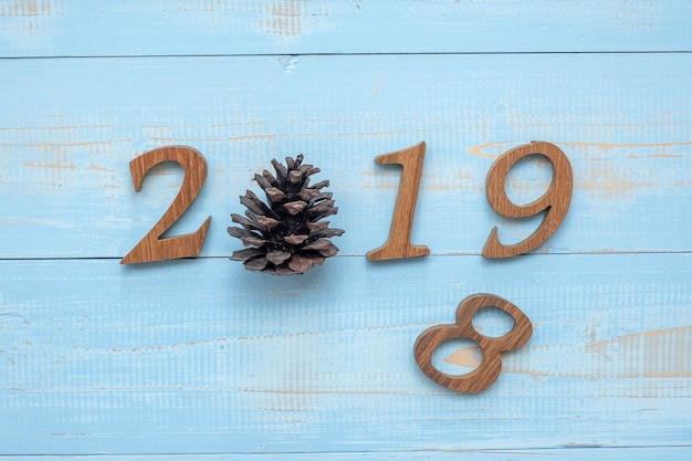 2018 - 2019 number with Christmas decorations on wooden background