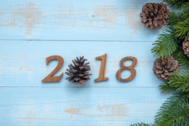 2018 number with Christmas decorations on wooden background