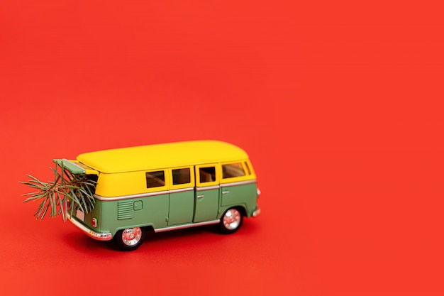 2019 miniature hippy car with fir tree on red background