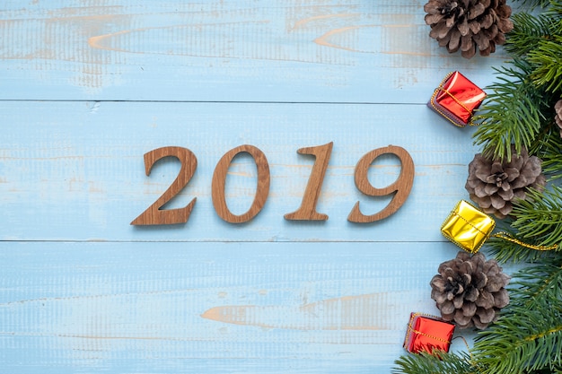 2019 number with Christmas decorations on wooden background
