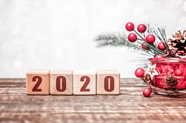 2020 new year concept with wooden cubes on wooden table 