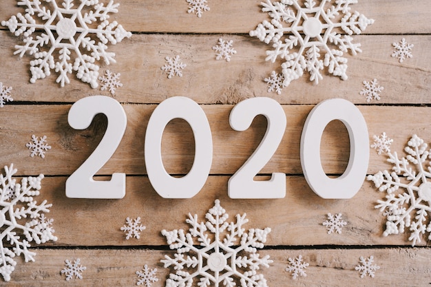 2020 New year concept on wood table and christmas decoration background.