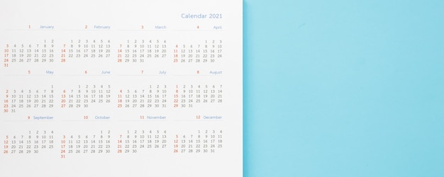 Photo 2021 calendar page on blue background business planning appointment meeting concept