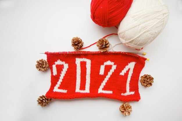 2021 Happy New Year. Knitted number. Skeins of yarn and pine cone. High quality photo