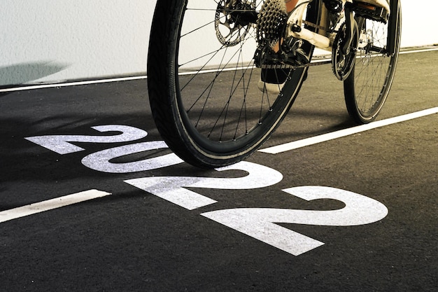 2022 on asphalt road with woman riding a bicycle. Happy New Year 2022