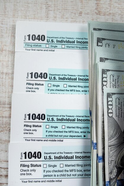 Photo 2022 blank tax form 1040 with us dollar biils