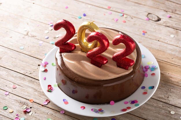 2022 cake and ornaments on wooden table