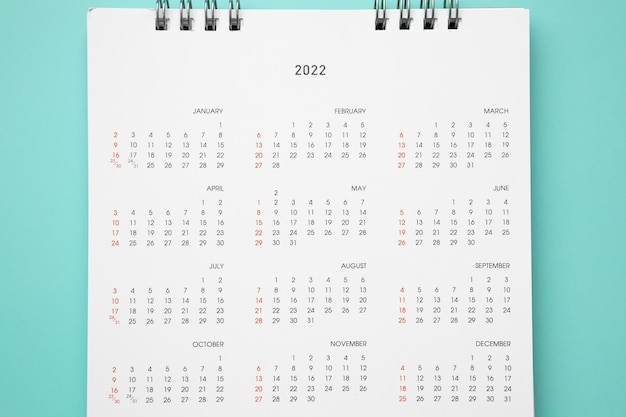 Photo 2022 calendar page on blue background business planning appointment meeting concept
