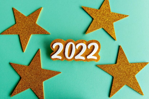 2022 on green background with stars, new year concept