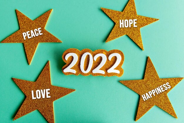 2022 on green background with stars, new year concept