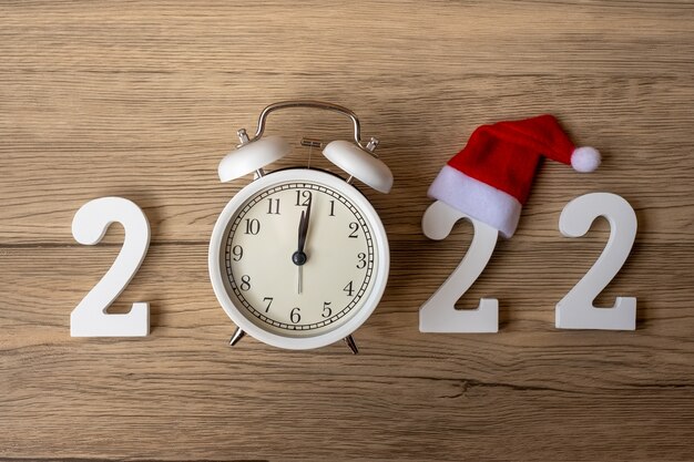 2022 Happy New Year  with retro alarm clock and wooden number. Merry Christmas, New Start, Resolution, countdown, Goals, Plan, Action and Mission Concept