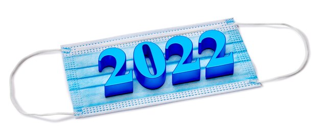 Photo 2022 new year numbers lie on medical mask. concept. 3d rendering