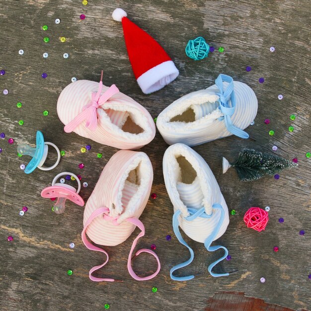 2022 new year written laces of children's shoes and pacifier on old wooden background. Top view. Flat lay.