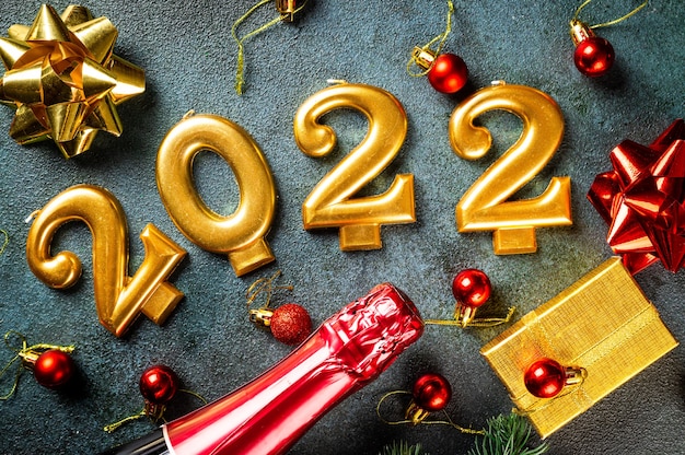 2022 number with champagne bottle and decor. Happy new year and festive concept. Top horizontal view, copyspace. New Year Flatly. Christmas flatlay. New year 2022. New year concept.