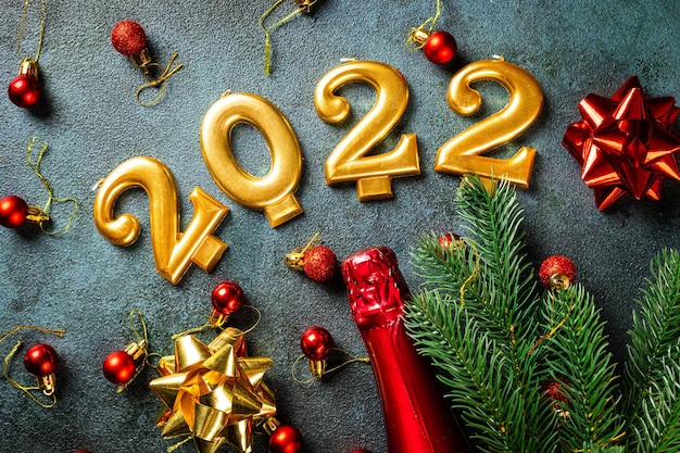 2022 number with champagne bottle and decor. Happy new year and festive concept. Top horizontal view, copyspace. New Year Flatly. Christmas flatlay. New year 2022. New year concept.