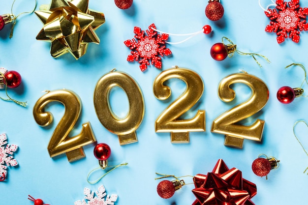 2022 number with champagne bottle and decor. Happy new year and festive concept. Top horizontal view, copyspace. New Year Flatly. Christmas flatlay. New year 2022. New year concept.