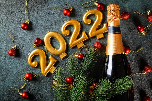 2022 numbers with champagne bottle and decor. Happy new year and festive concept. Top horizontal view copyspace. New Year Flatly. Christmas flatlay. New year 2022. New year concept.