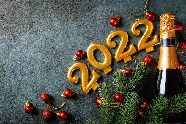 2022 numbers with champagne bottle and decor. Happy new year and festive concept. Top horizontal view copyspace. New Year Flatly. Christmas flatlay. New year 2022. New year concept.